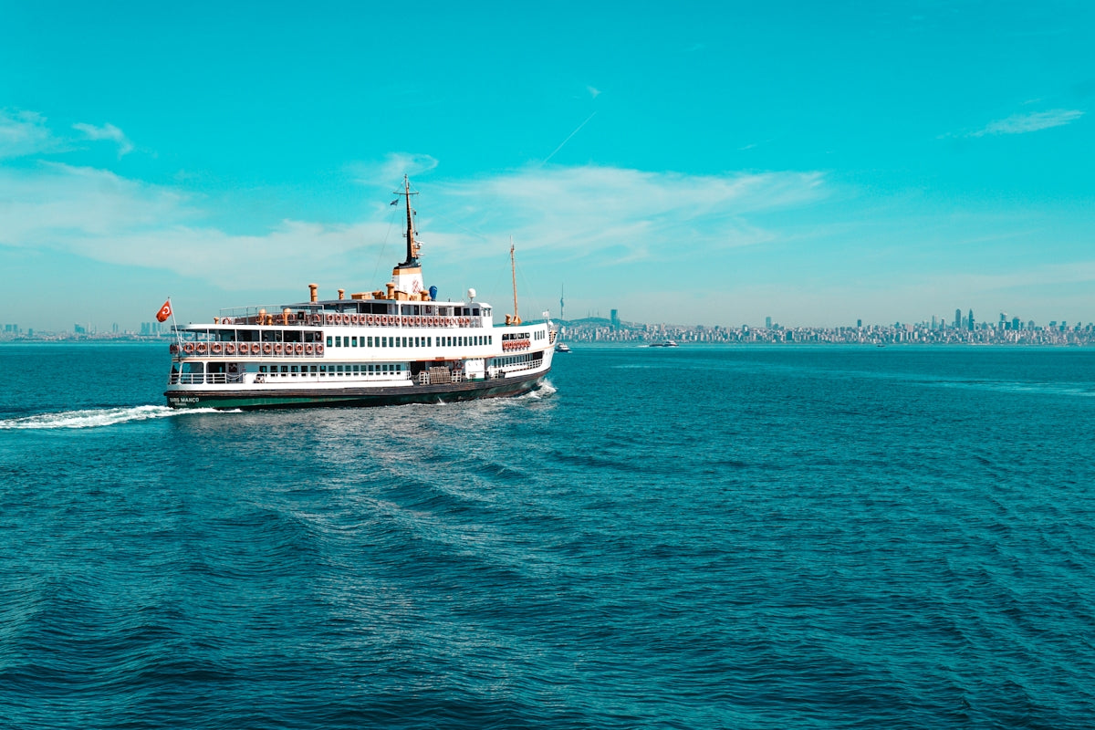 white ship on sea under blue sky during daytime